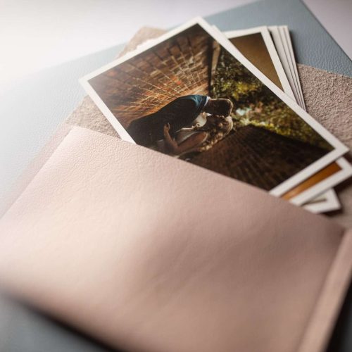 A leather pouch holding wedding photos and printed on high quality fine art paper