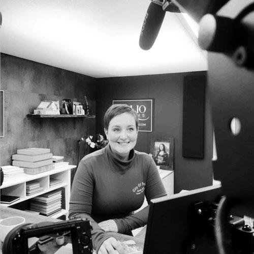 A black and white photo showing one of the Folio Albums team helping a photographer via a Zoom call.