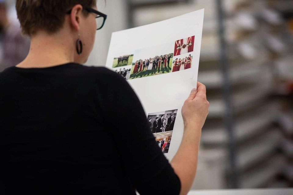 A member of the Folio workshop inspect the quality of a photo book fine art page