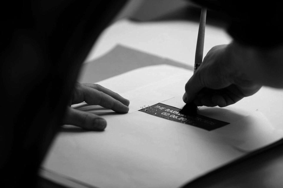 A member of the Folio team adding real gold to a wedding album