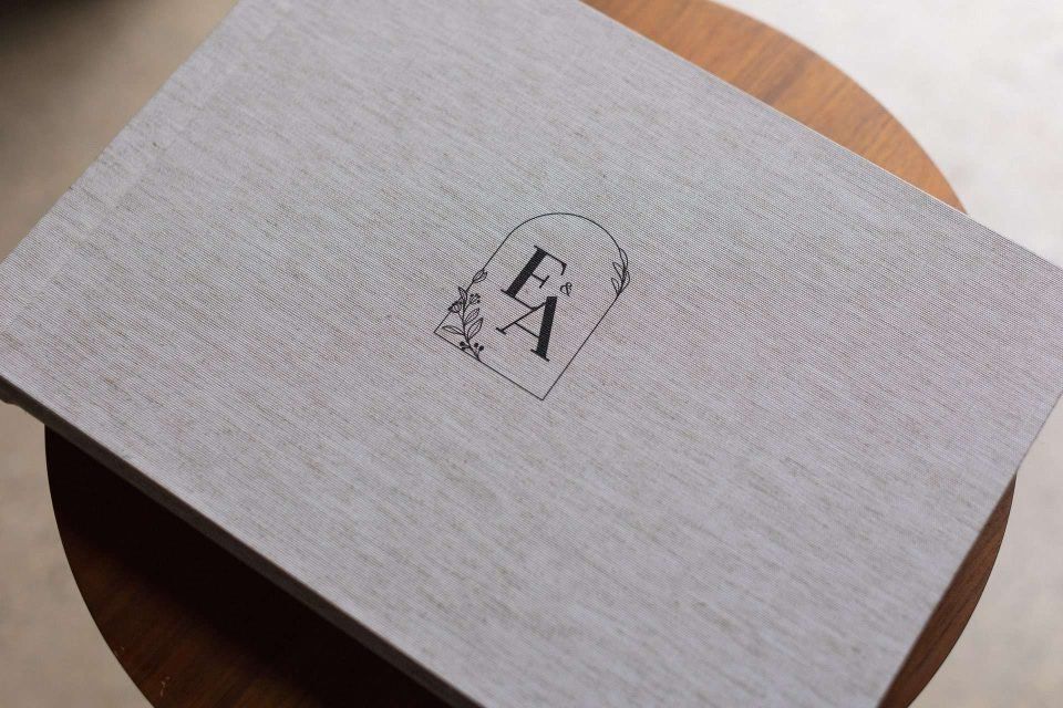 Black printing on the lid of a box of a photographer's logo