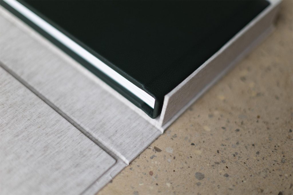 A details shot of an opened clamshell box with a quality Folio fine art photo album inside