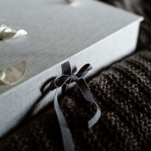 A handmade quality clamshell box with a ribbon tie closure