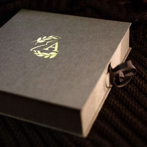 A bespoke made to order clamshell box with gold foiling on the lid