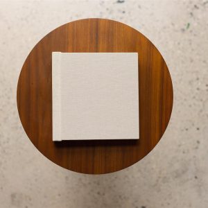 A handmade luxury wedding album on a table shot from above