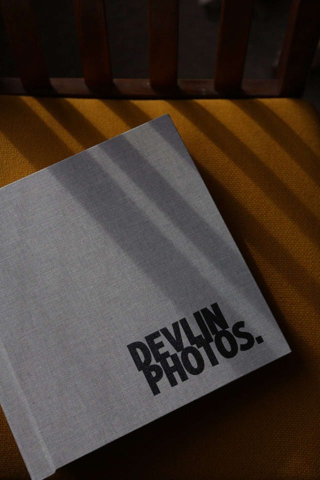 A top down photo of a stunning bespoke photo album with the photographer's logo printed in black
