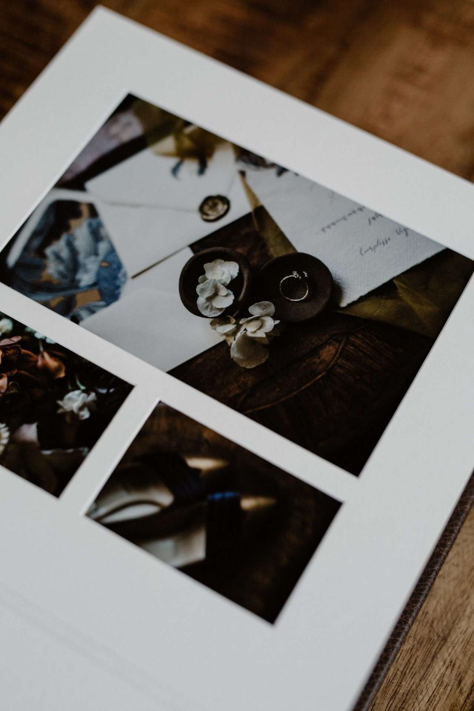 A closeup of a matted album page show the detail of the cut apertures and the exquisite fine art printing