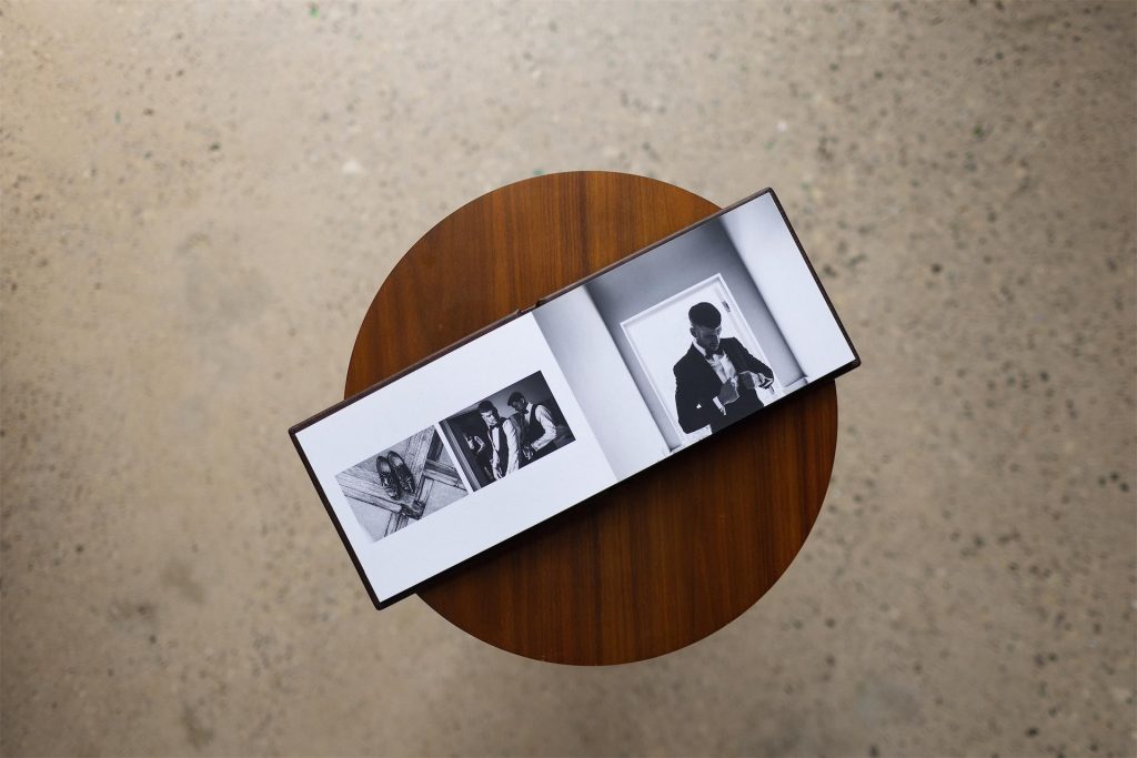 A mini copy album open to show an entire printed spread on a table and shot from above