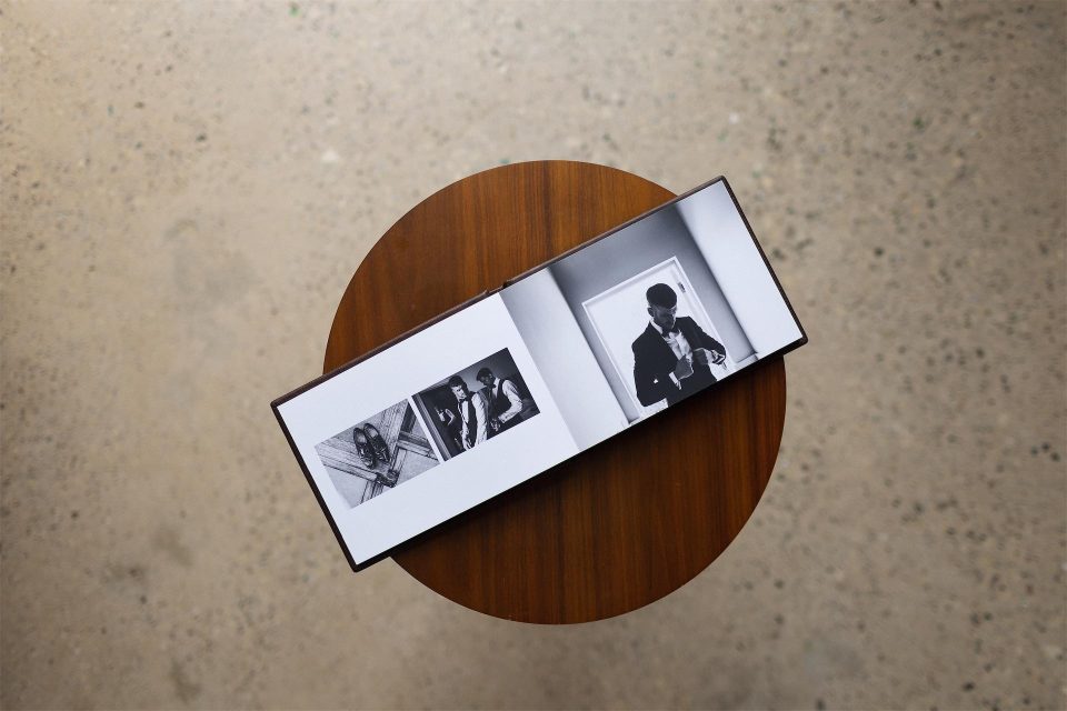 A mini copy album open to show an entire printed spread on a table and shot from above