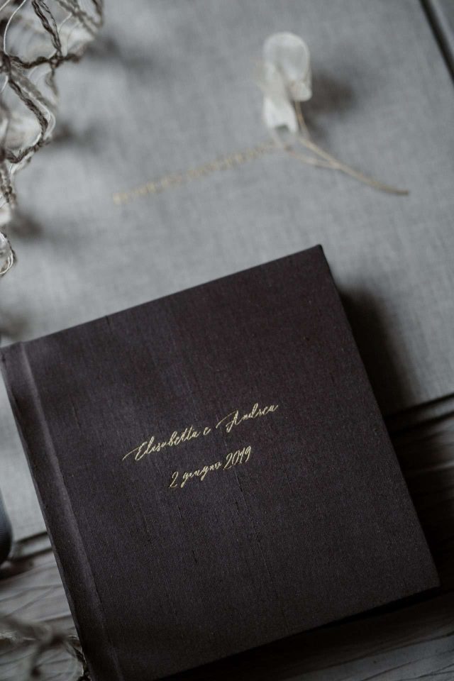 A silk mini album with gold cover text in a script font