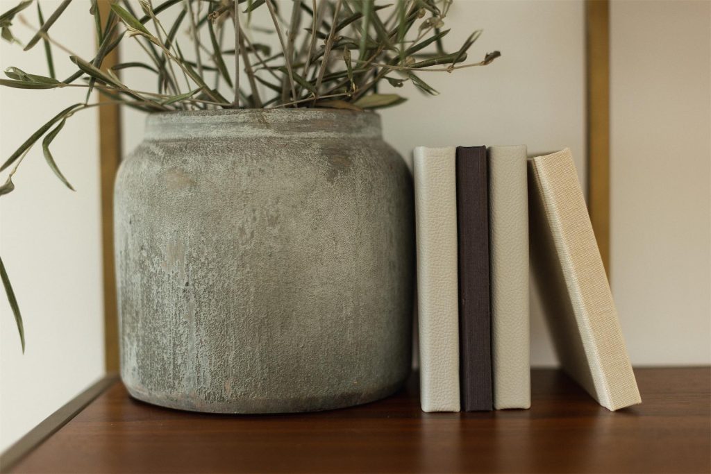 A closer image showing a collection of fabric and leather square mini albums on a shelf