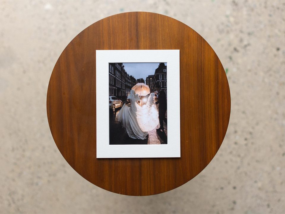 A shot of a matted print on a table with a creative wedding photo printed on fine art paper
