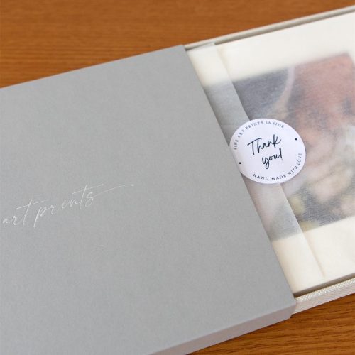 A thank you box holding mounted fine art prints used as a gift by a photographer to their clients