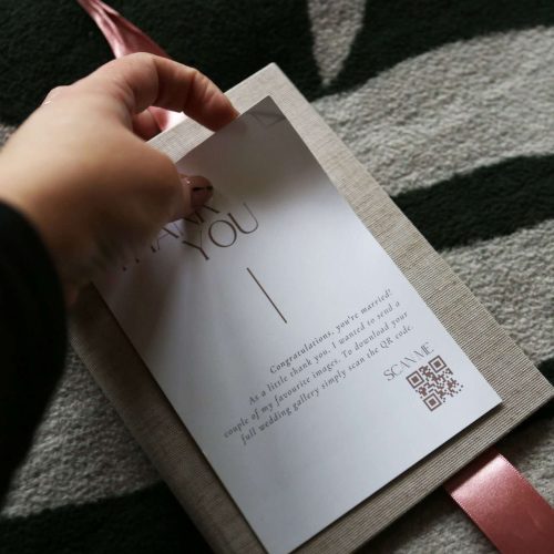 A thank you folio gift from a photographer to their client with a QR code to an album design to increase album sales