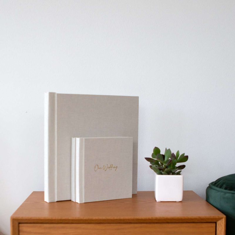 A large and smaller photo album next to each other on a table
