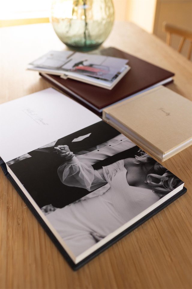 A collection of UK handmade luxury wedding albums on a table
