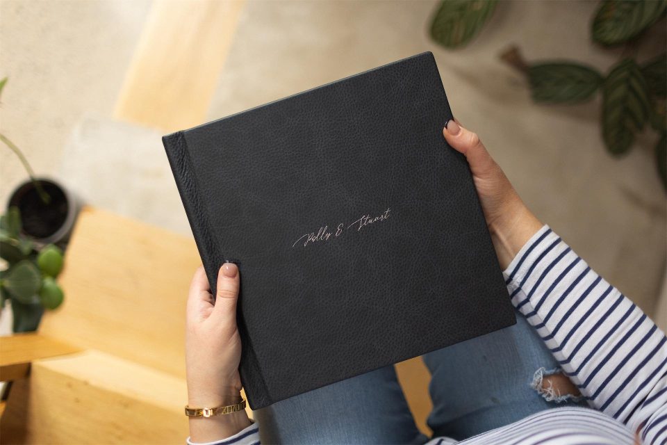 A vintage leather bound wedding album with beautiful silver names on the cover