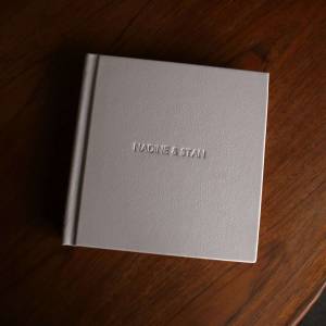 A bespoke luxury leather wedding album with names embossed on the front cover