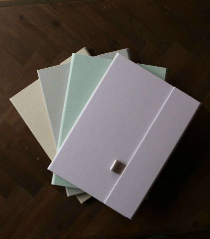 A collection of four different coloured luxury print folders
