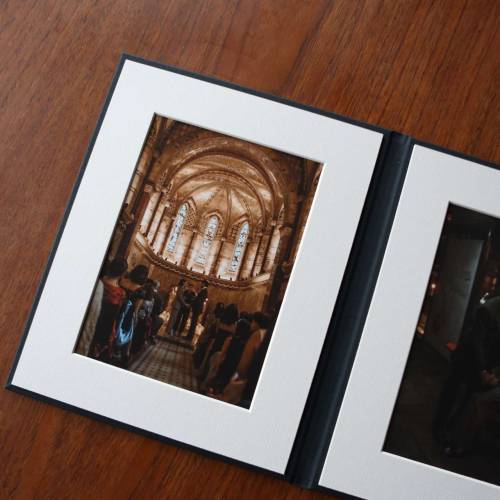 A handmade photo folio in portrait style with fine art prints on a table