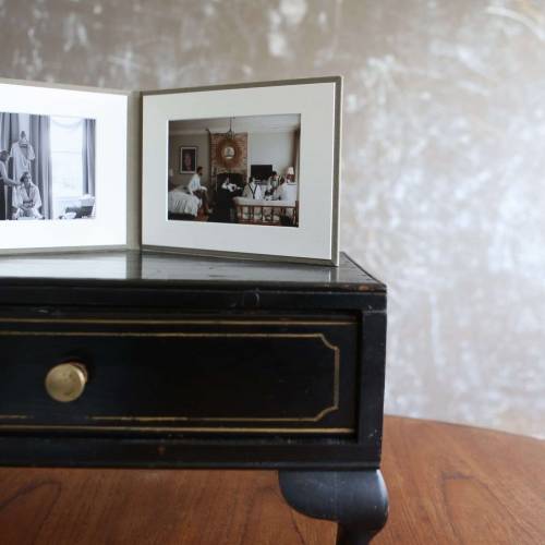 A presentation folio in landscape format with fine art prints on a table