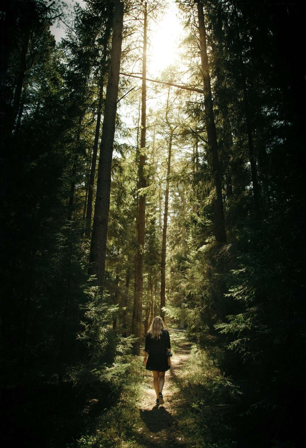 Woman walking in green forest