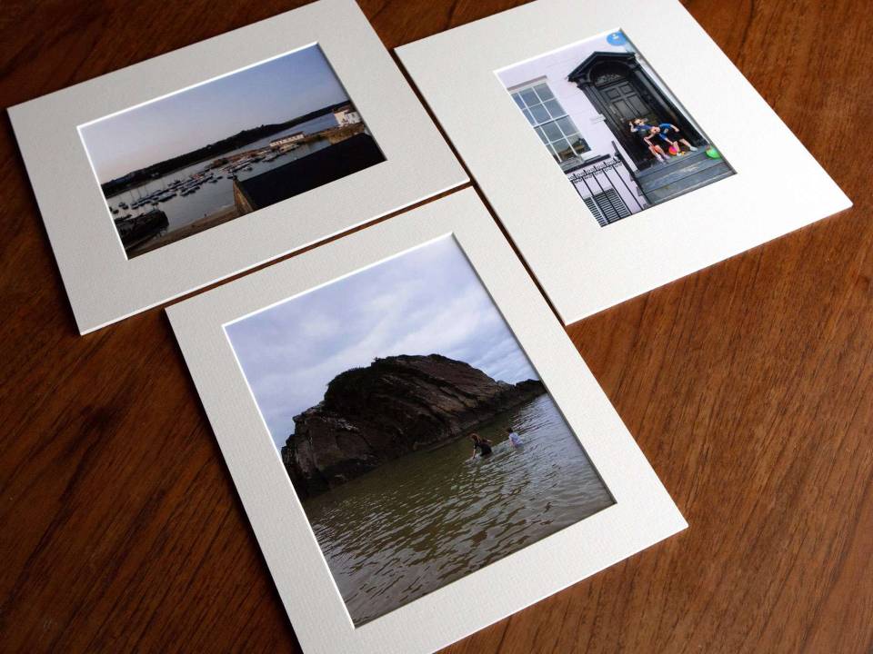 A collection of different sized mounted matted prints