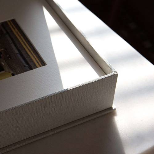 A detail shot of a handmade in the UK print box holding matted photographic prints